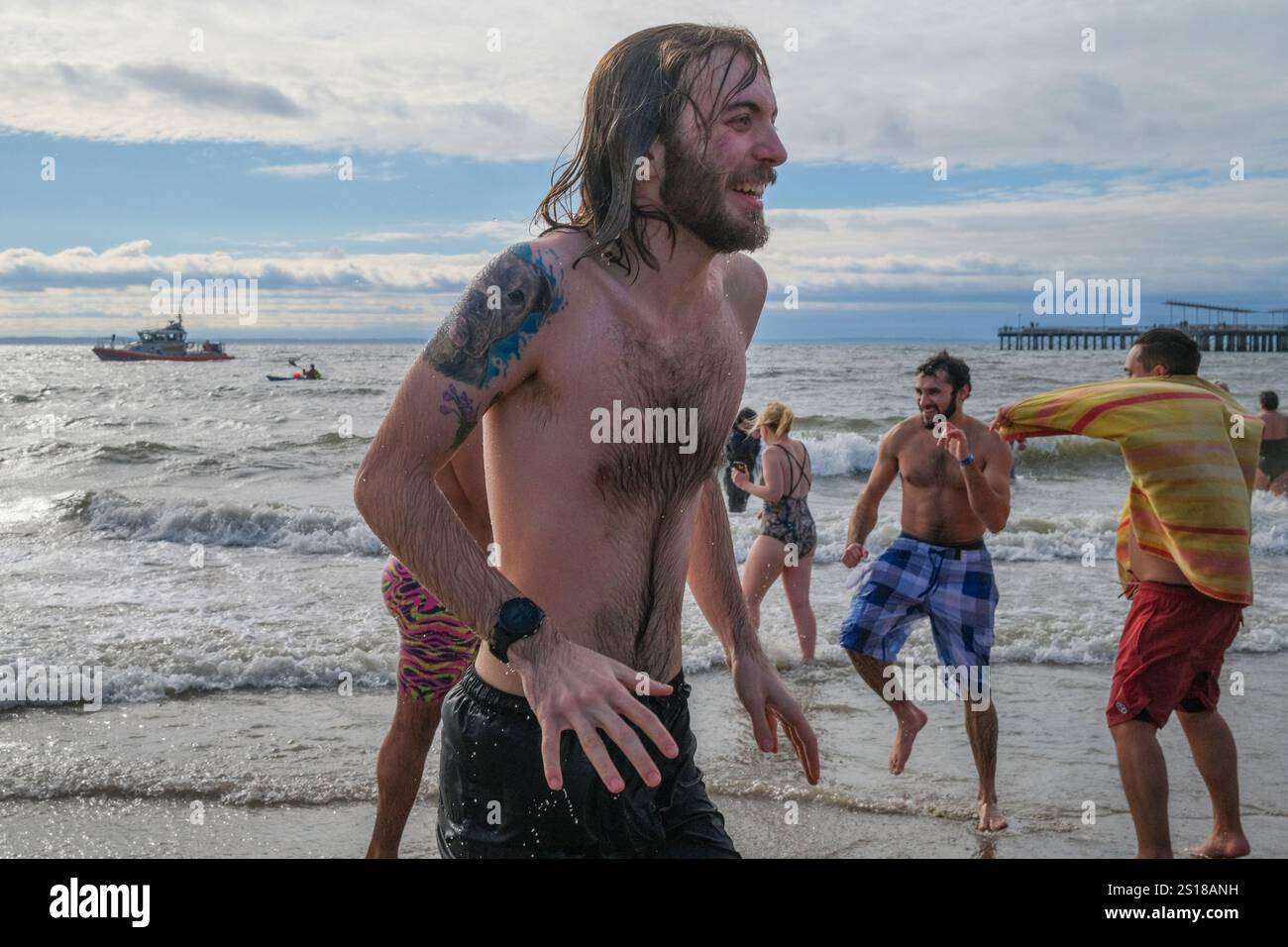 New York, New York, USA. 1st Jan, 2025. The annual Coney Island Polar Plunge took place under variable .cloudy skies and frigid Atlantic waters. The event by the Coney Island Polar bear Club since. 1903 drew thousands to the beach New Years day supporting non profits. (Credit Image: © Milo Hess/ZUMA Press Wire) EDITORIAL USAGE ONLY! Not for Commercial USAGE! Stock Photo