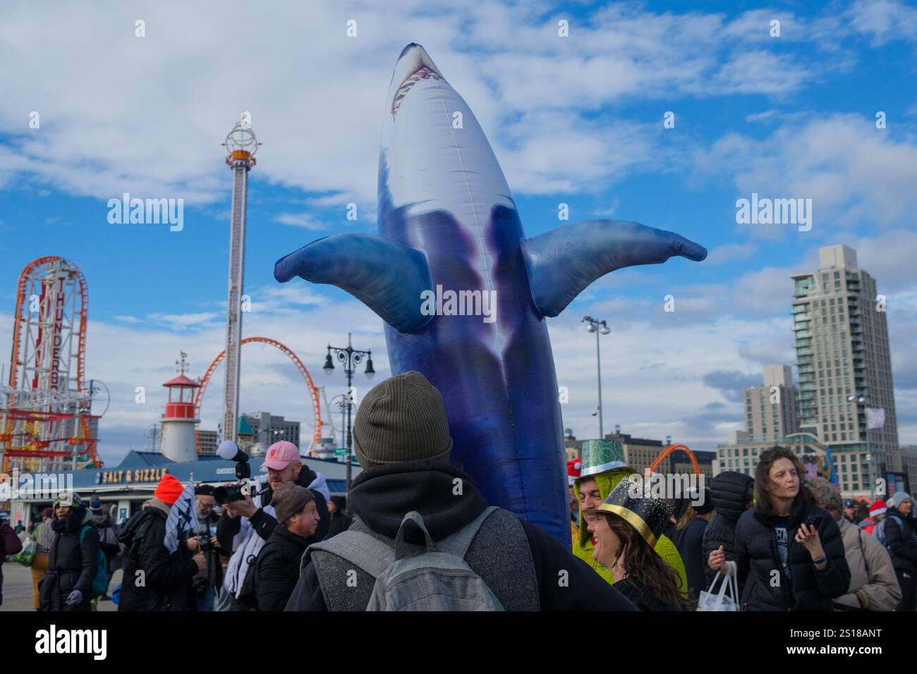 New York, New York, USA. 1st Jan, 2025. The annual Coney Island Polar Plunge took place under variable .cloudy skies and frigid Atlantic waters. The event by the Coney Island Polar bear Club since. 1903 drew thousands to the beach New Years day supporting non profits. (Credit Image: © Milo Hess/ZUMA Press Wire) EDITORIAL USAGE ONLY! Not for Commercial USAGE! Stock Photo