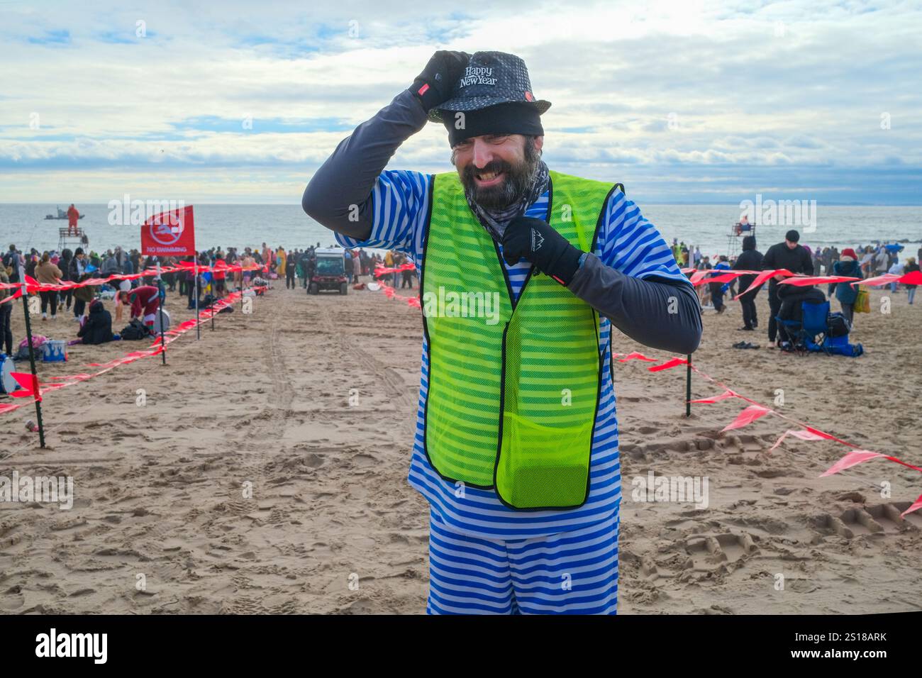 New York, New York, USA. 1st Jan, 2025. The annual Coney Island Polar Plunge took place under variable .cloudy skies and frigid Atlantic waters. The event by the Coney Island Polar bear Club since. 1903 drew thousands to the beach New Years day supporting non profits. (Credit Image: © Milo Hess/ZUMA Press Wire) EDITORIAL USAGE ONLY! Not for Commercial USAGE! Stock Photo