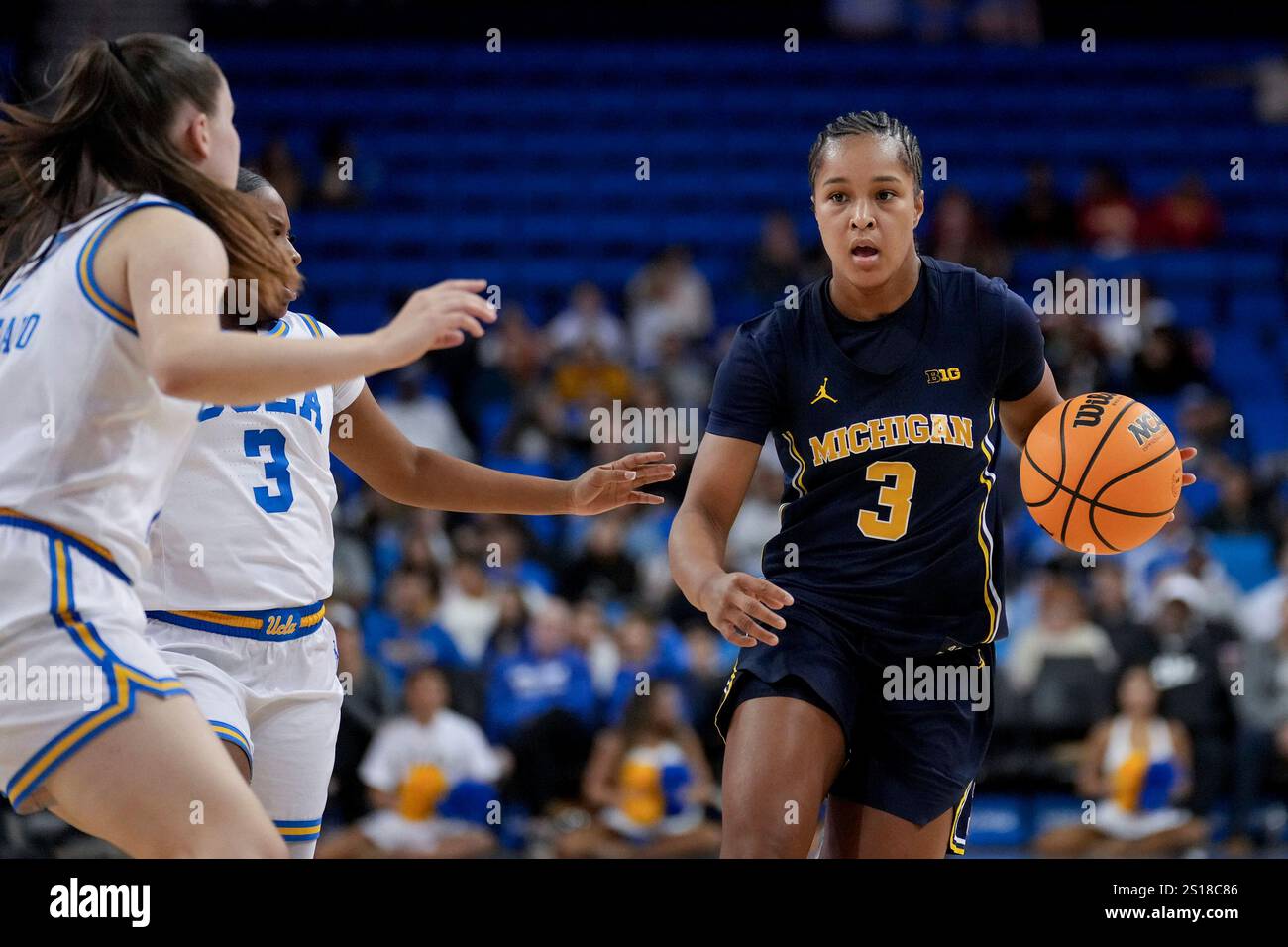 Michigan guard Mila Holloway (3) dribbles against UCLA guards Elina