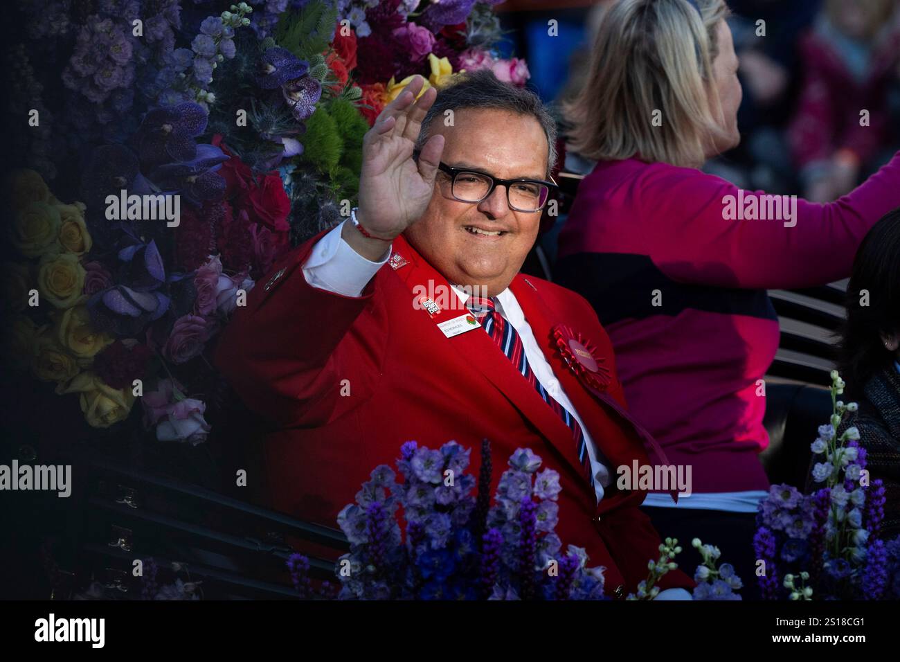 The 2025 Pasadena Tournament of Roses President Ed Morales waves to