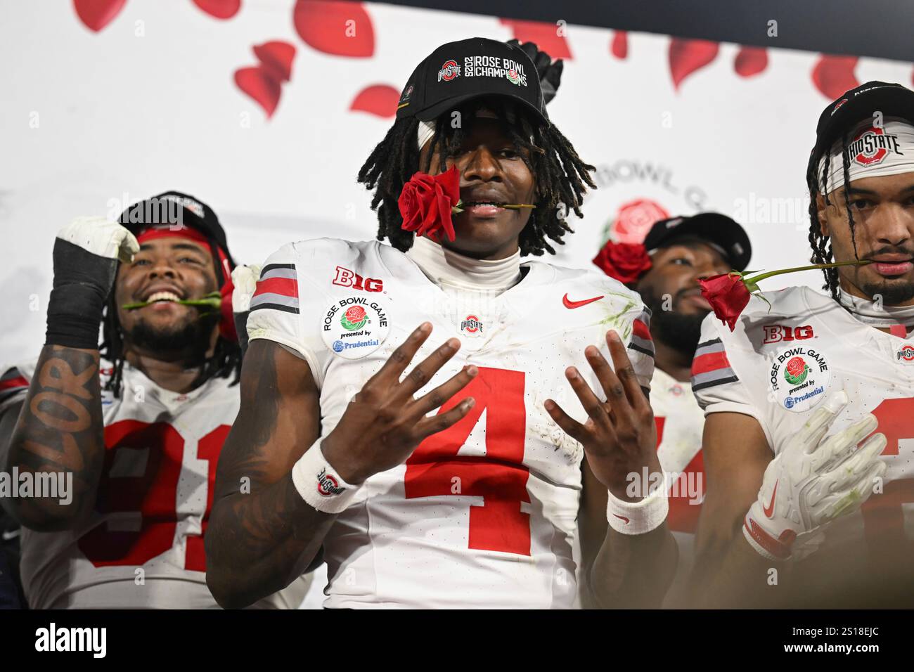 Ohio State wide receiver Jeremiah Smith (4) holds a rose in his mouth