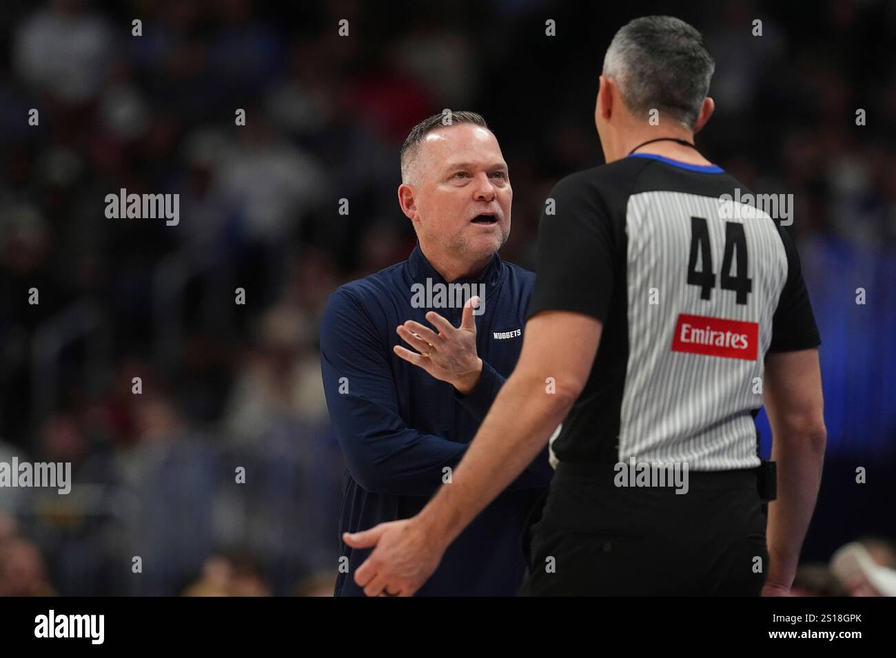 Denver Nuggets head coach Michael Malone, left, argues for a call with