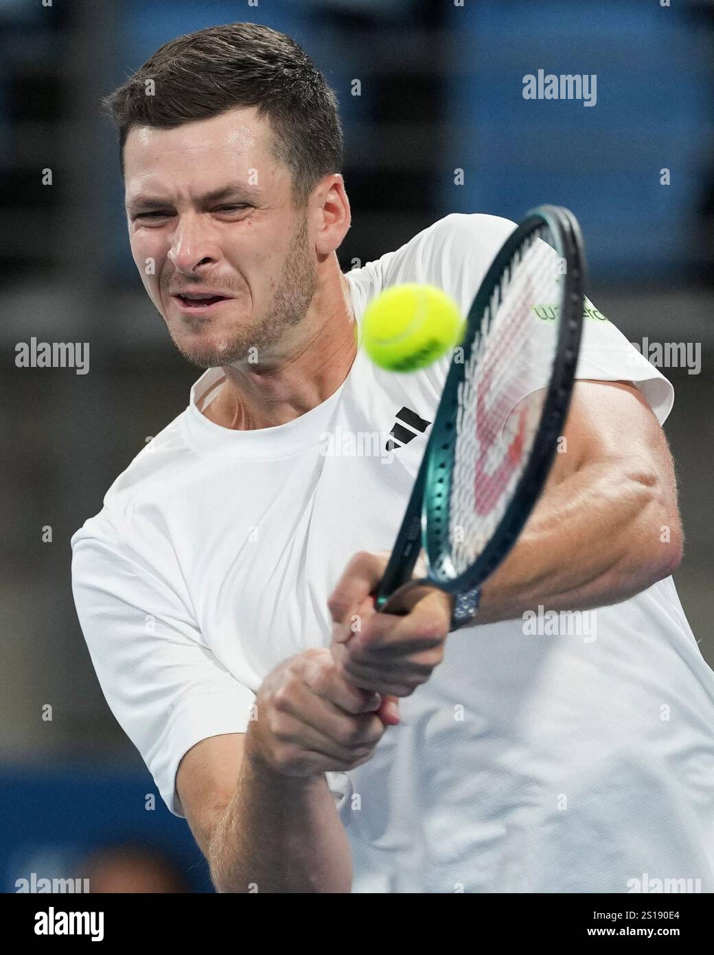Poland's Hubert Hurkaz plays a backhand return to Britain's Billy