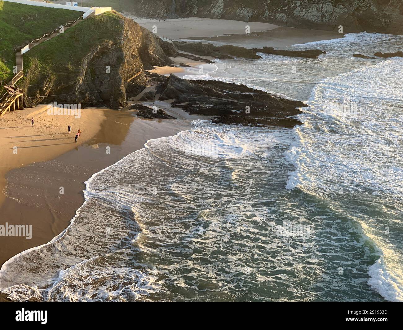 A breathtaking view over calm waters, with the sun's golden rays reflecting beautifully on the surface, signaling the start of a peaceful day. - Smartphone Captured Stock Image