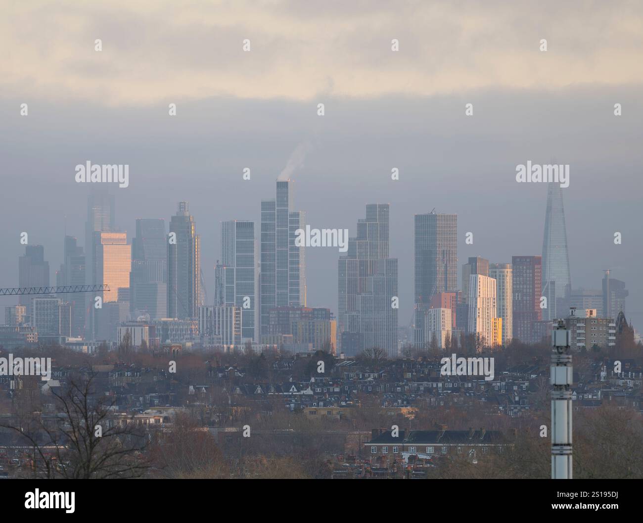 Wimbledon, London, UK. 2nd Jan, 2024. After a long period of grey skies over the festive season and a very wet New Years Day, clouds clear over London to give two days of cold sunshine and blue skies. Sunlight at sunrise strikes the east facing sides of city skyscrapers in the distance Credit: Malcolm Park/Alamy Live News Stock Photo