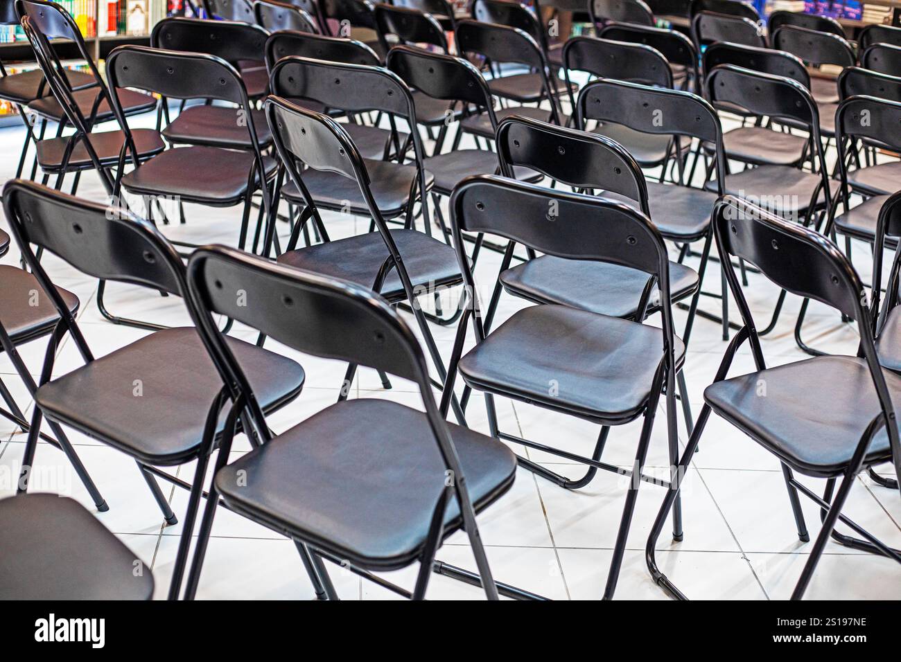 empty folding black chairs after the conference in the library interior Stock Photo