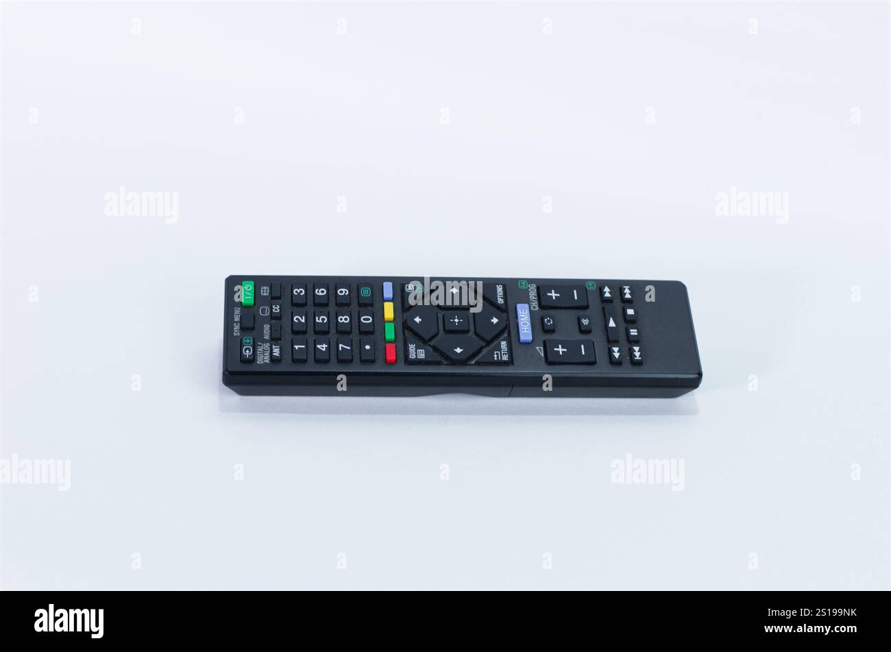 Black Wireless TV Remote Control Placed on a Clean White Surface Stock Photo