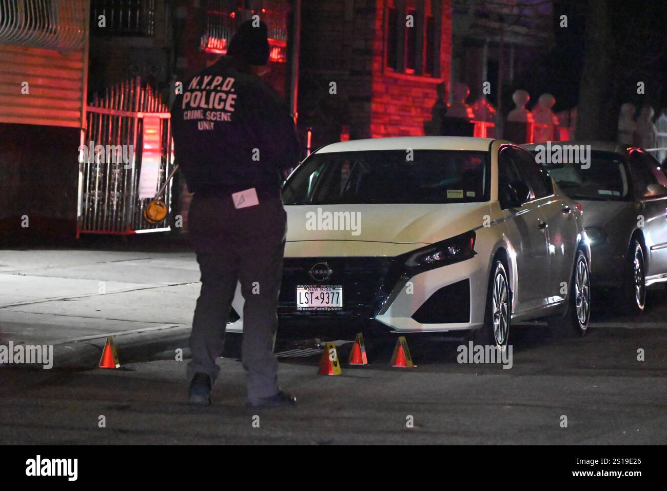 NYPD police officers place down evidence markers and collect shell ...