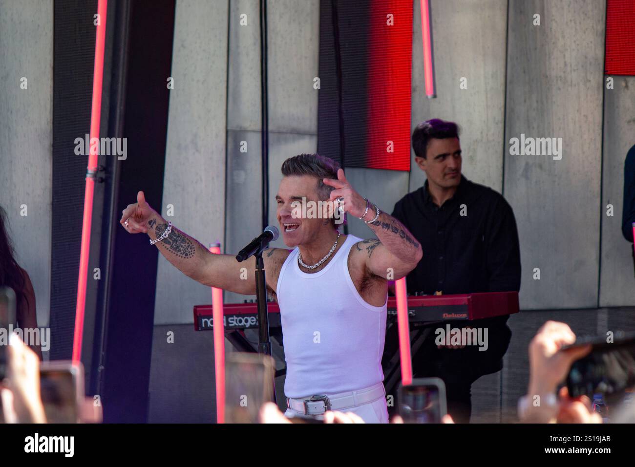 Robbie Williams performing for the crowd. Robbie Williams performing a ...