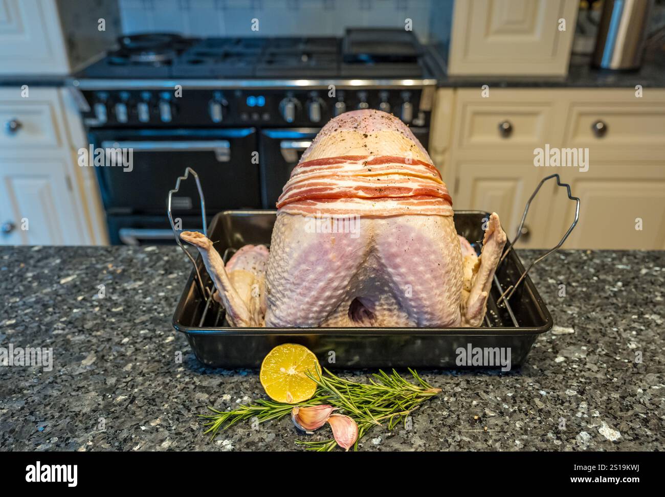 A turkey crown in a roasting tin on a kitchen counter ready for cooking in the oven for Christmas dinner, UK Stock Photo