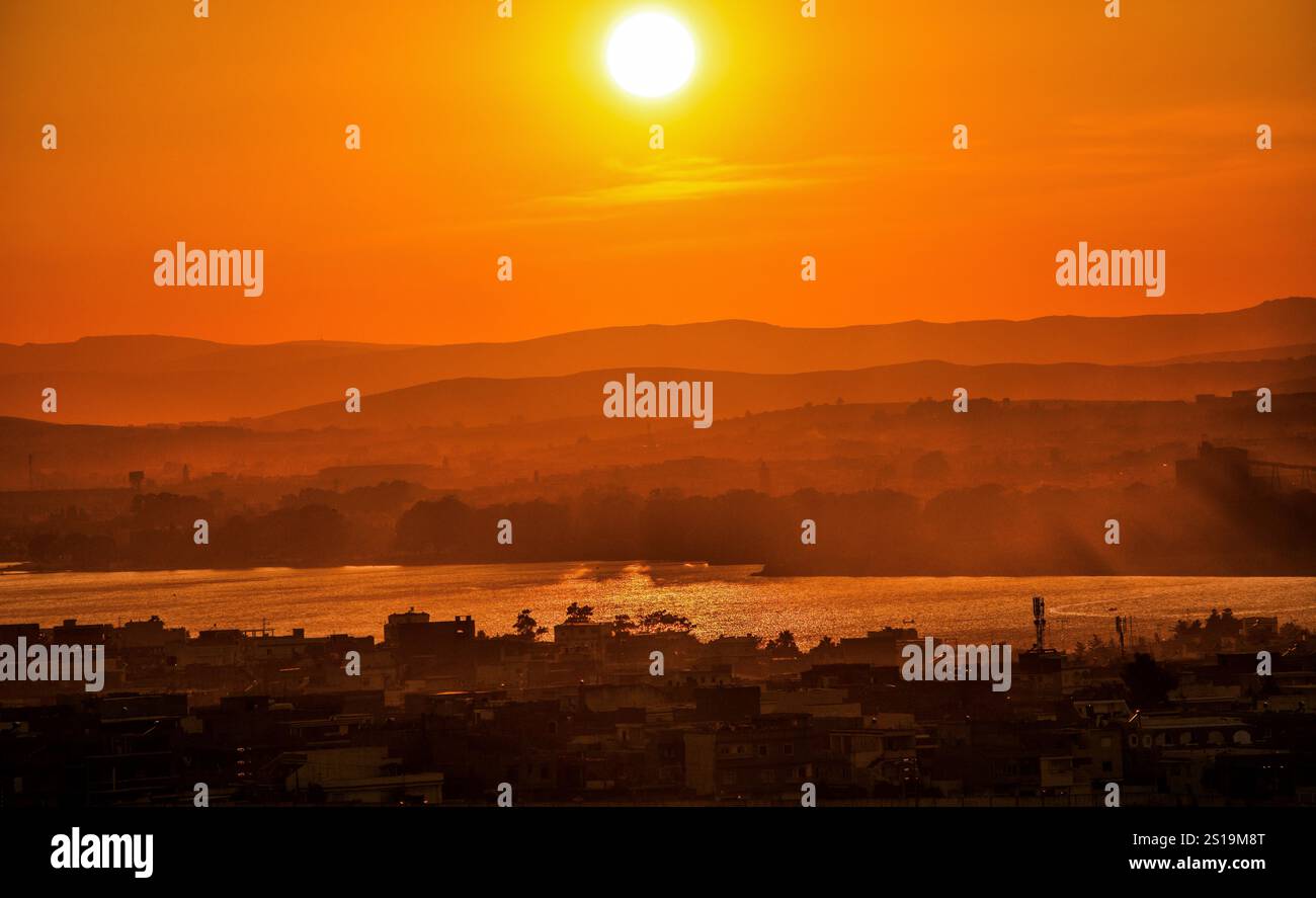 A serene sunset framed by the beauty of the wild. Stock Photo