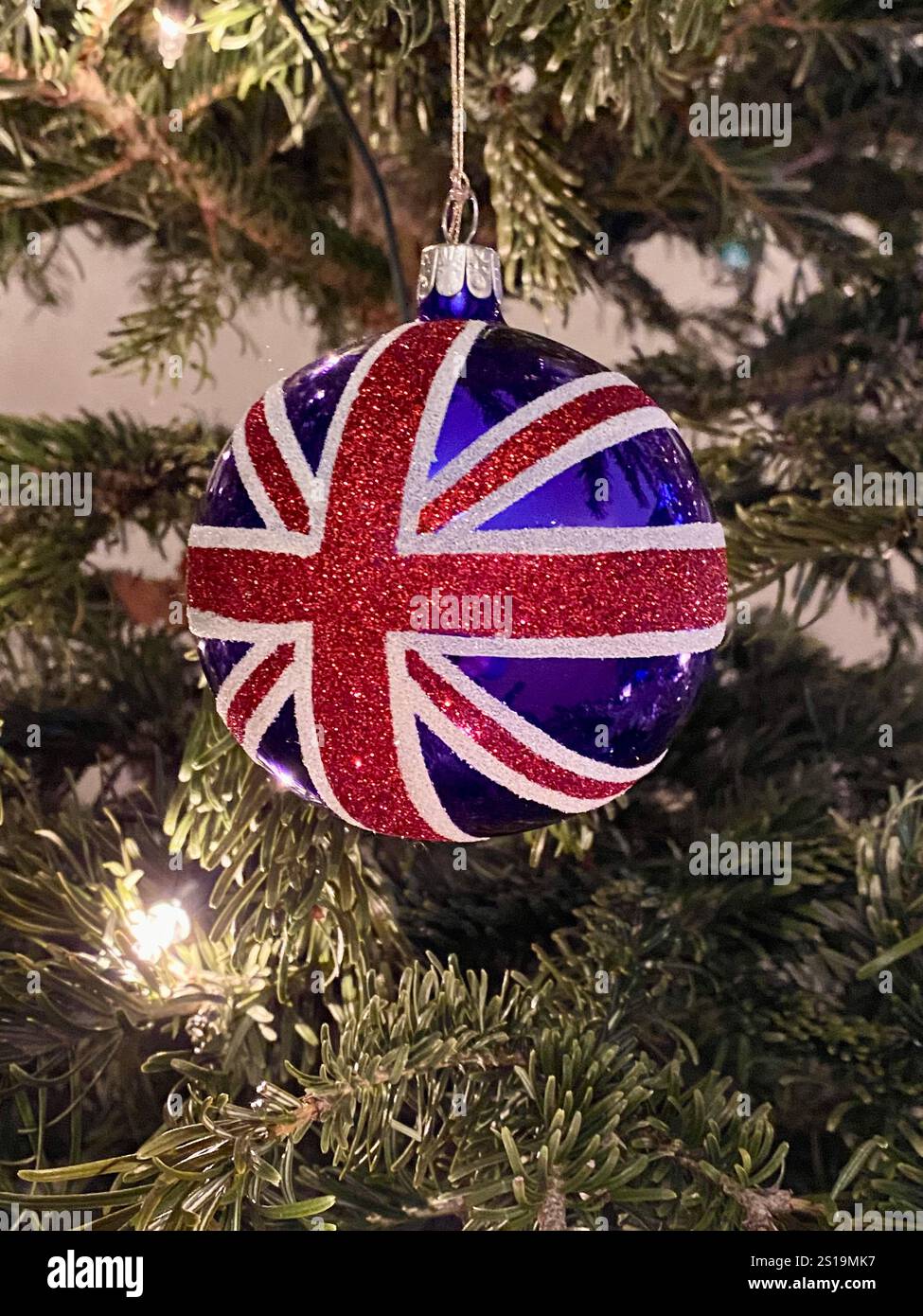 Festive Christmas Tree Ornament with Union Jack Design in Holiday Setting - Smartphone Captured Stock Image