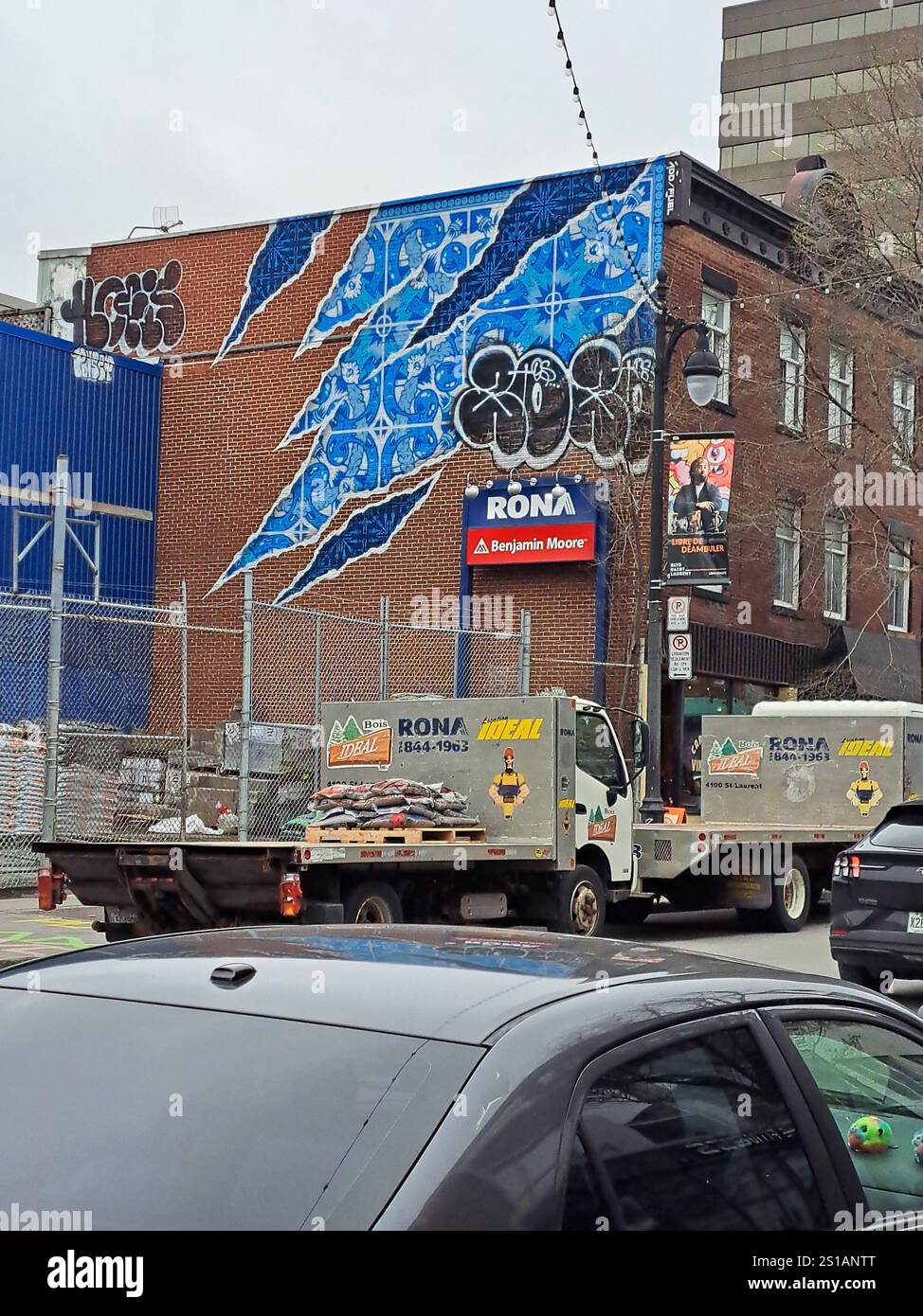 Torn wallpaper mural on Rona Benjamin Moore building on Saint-Laurent ...