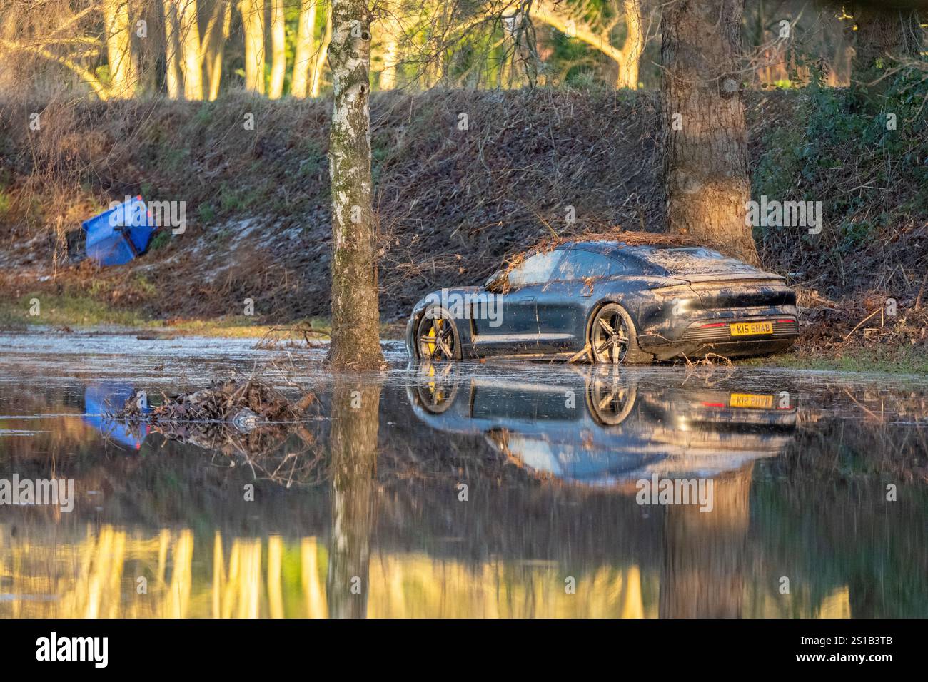 Northenden Golf club which has been completly submerged in water and debris following flooding in Manchester. Debris and water covered the course with the club house cut off from dryland. A Porsche car was covered in debris from the flood water with flags barely showing over the water on some greens. The clean up begins following extensive flooding in South Manchester following heavy rain at the start of the New Year. Northenden Golf Club ( near Didsbury) was flooded with cars including a Porsche covered in debris by the flood water. The course has been completely flooded with water and debris Stock Photo