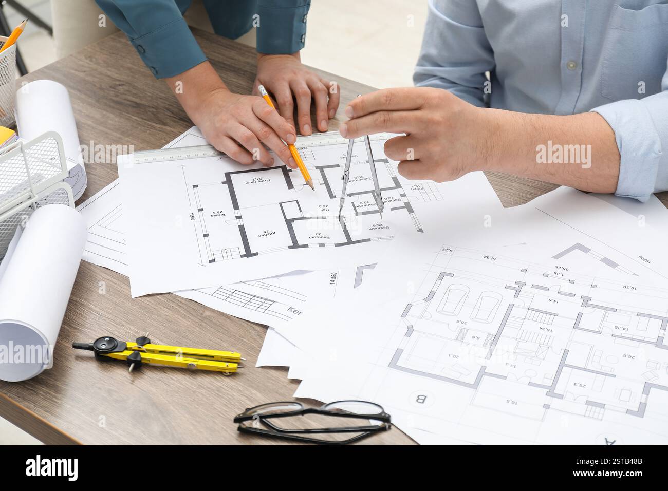 Architects working with project, closeup. Different technical drawings on wooden table Stock Photo