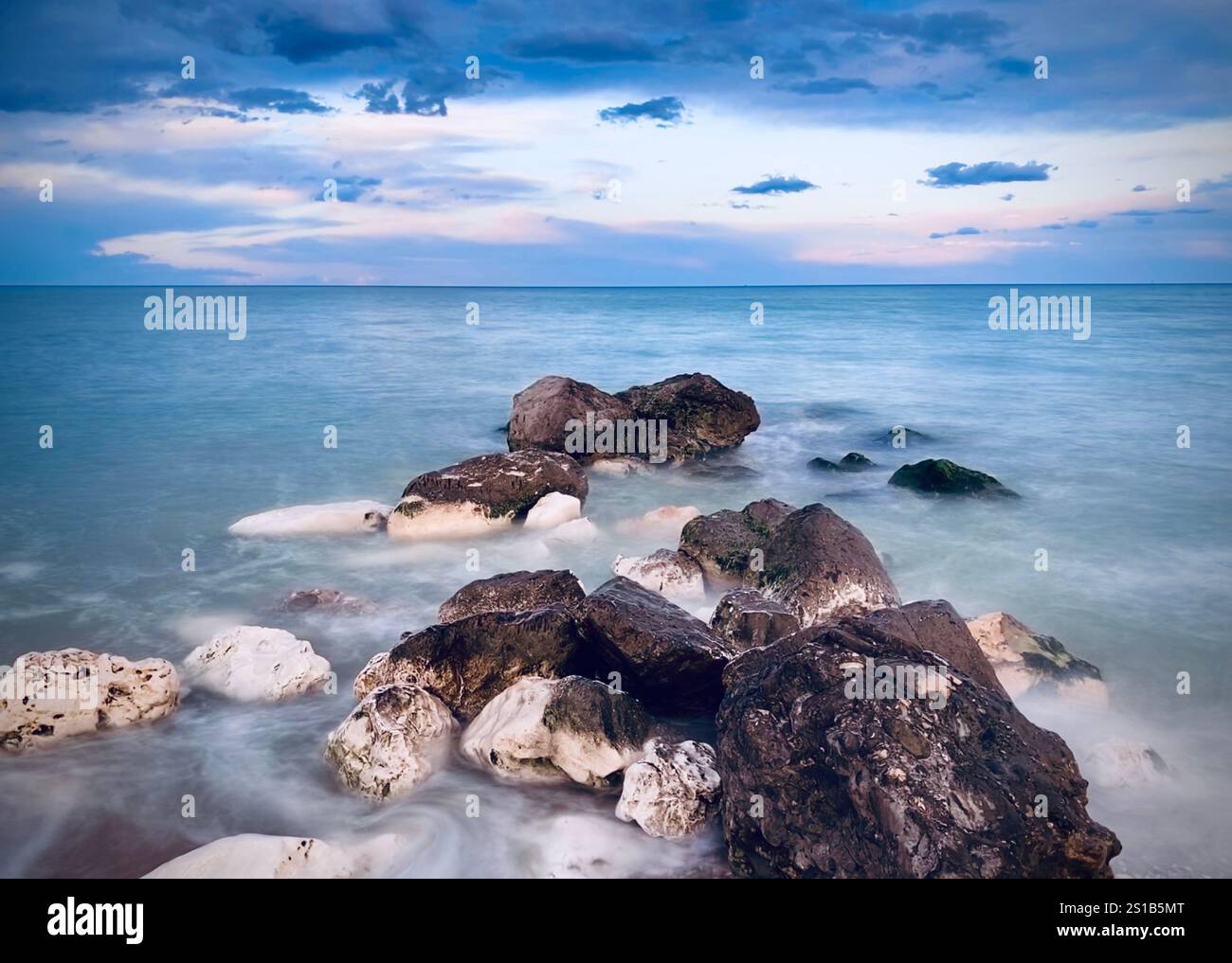 Long exposure of rocks in Sea, Italy - Smartphone Captured Stock Image