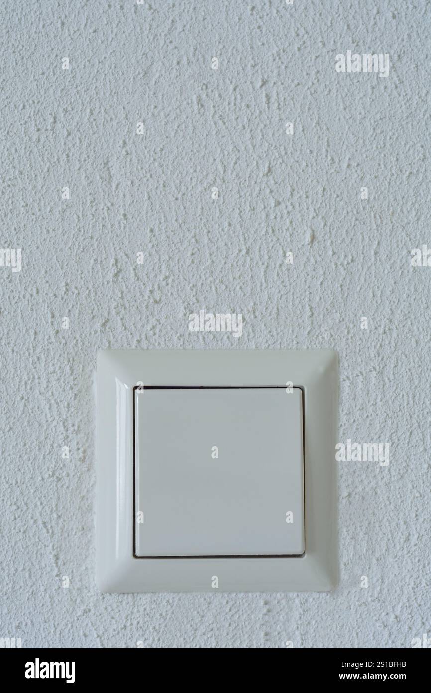 light switch on a white wall Stock Photo