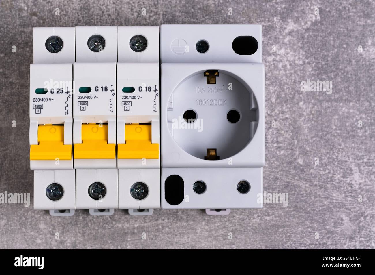 Electrical fuse box and socket on gray background. View from above. Copy space Stock Photo