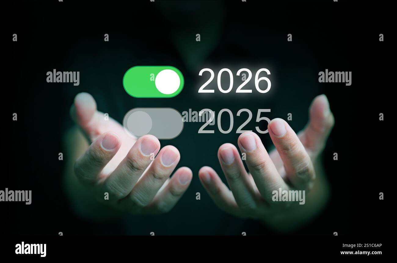 Happy new year 2026. A man, with both hands, holds an onswitch of 2026