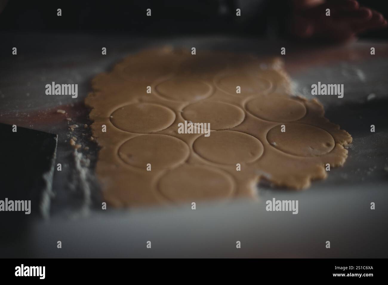 peruvian alfajores (cookies) being prepared to go to the oven, kitchen marble working bench, pastry dough being worked Stock Photo