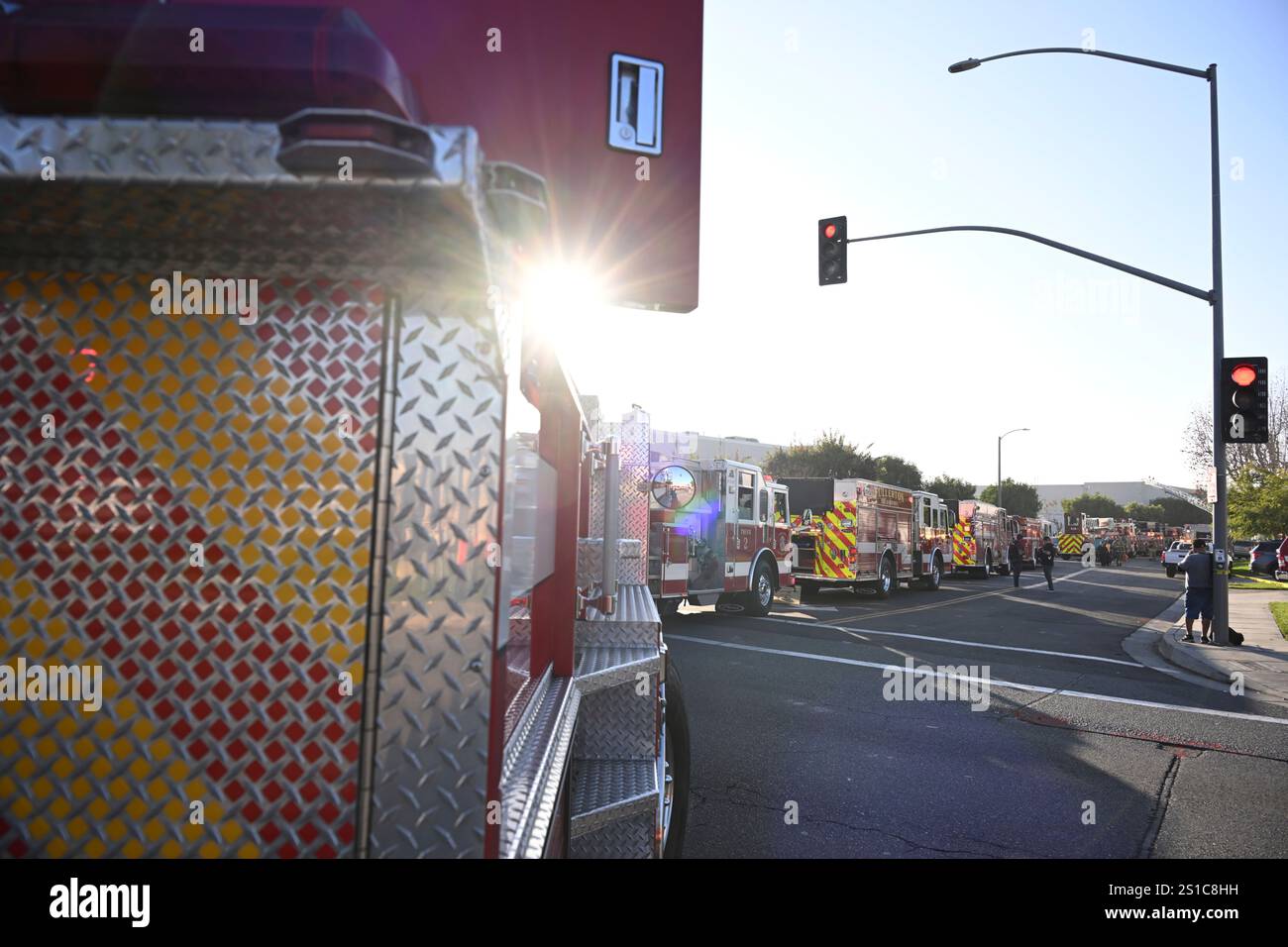 Emergency vehicles are lined up near the site of a plane crash