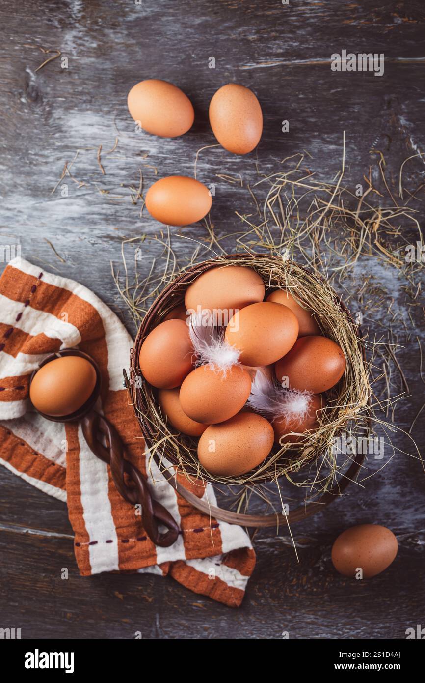 Organic brown eggs in a basket on kitchen table Stock Photo