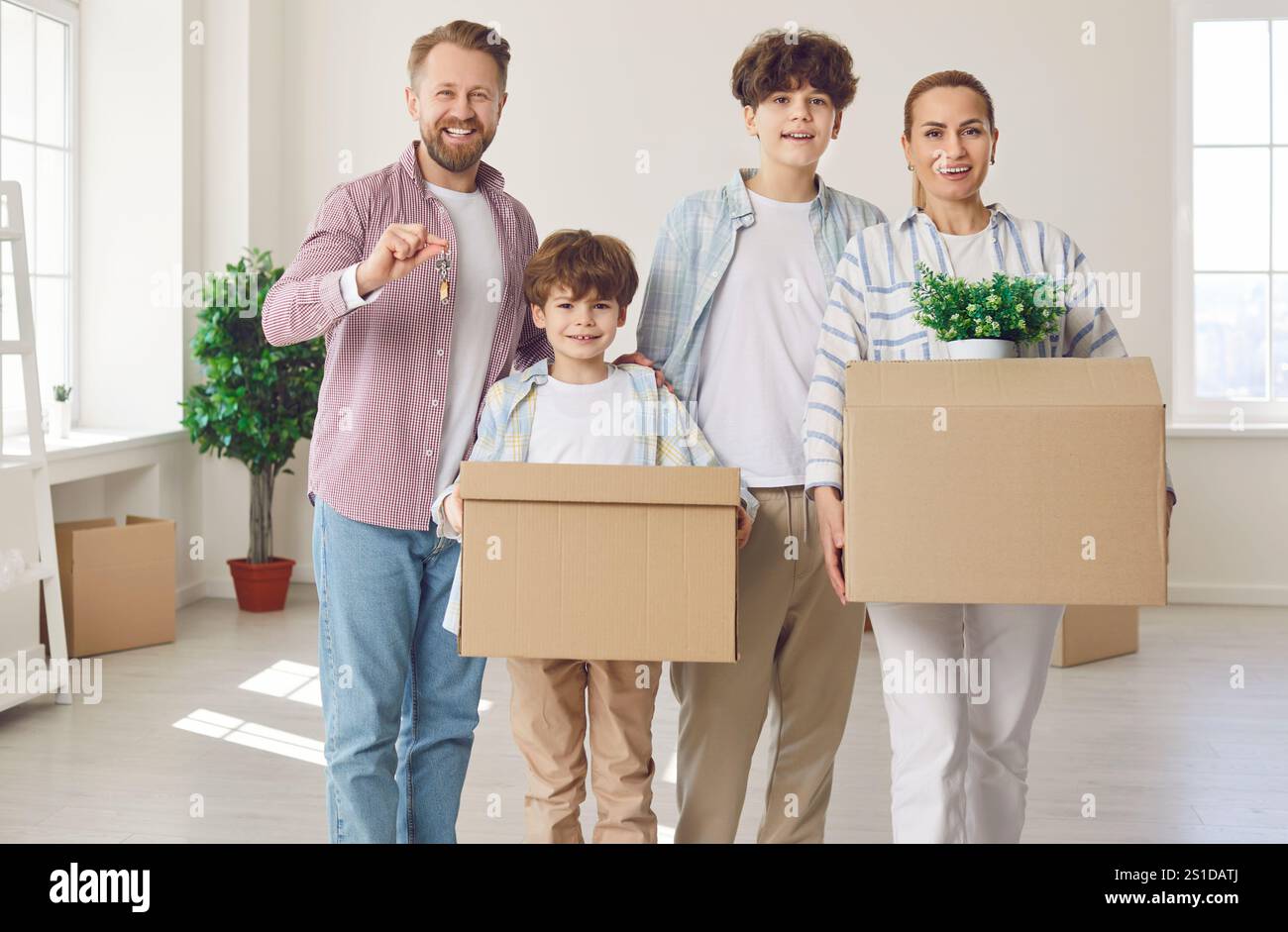 Happy Family Portrait Celebrating Relocation to New Home and Holding ...
