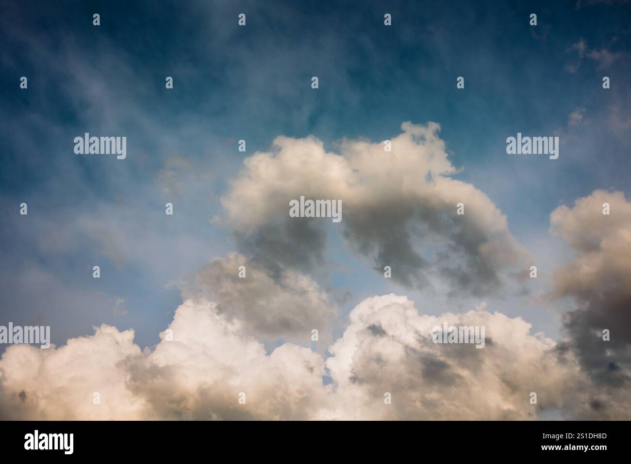 Fluffy White Clouds in a blue summer sky Stock Photo