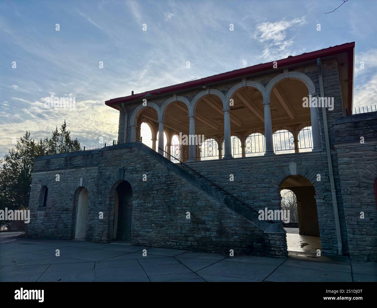 Historic stone building with arched columns and a staircase Stock Photo ...