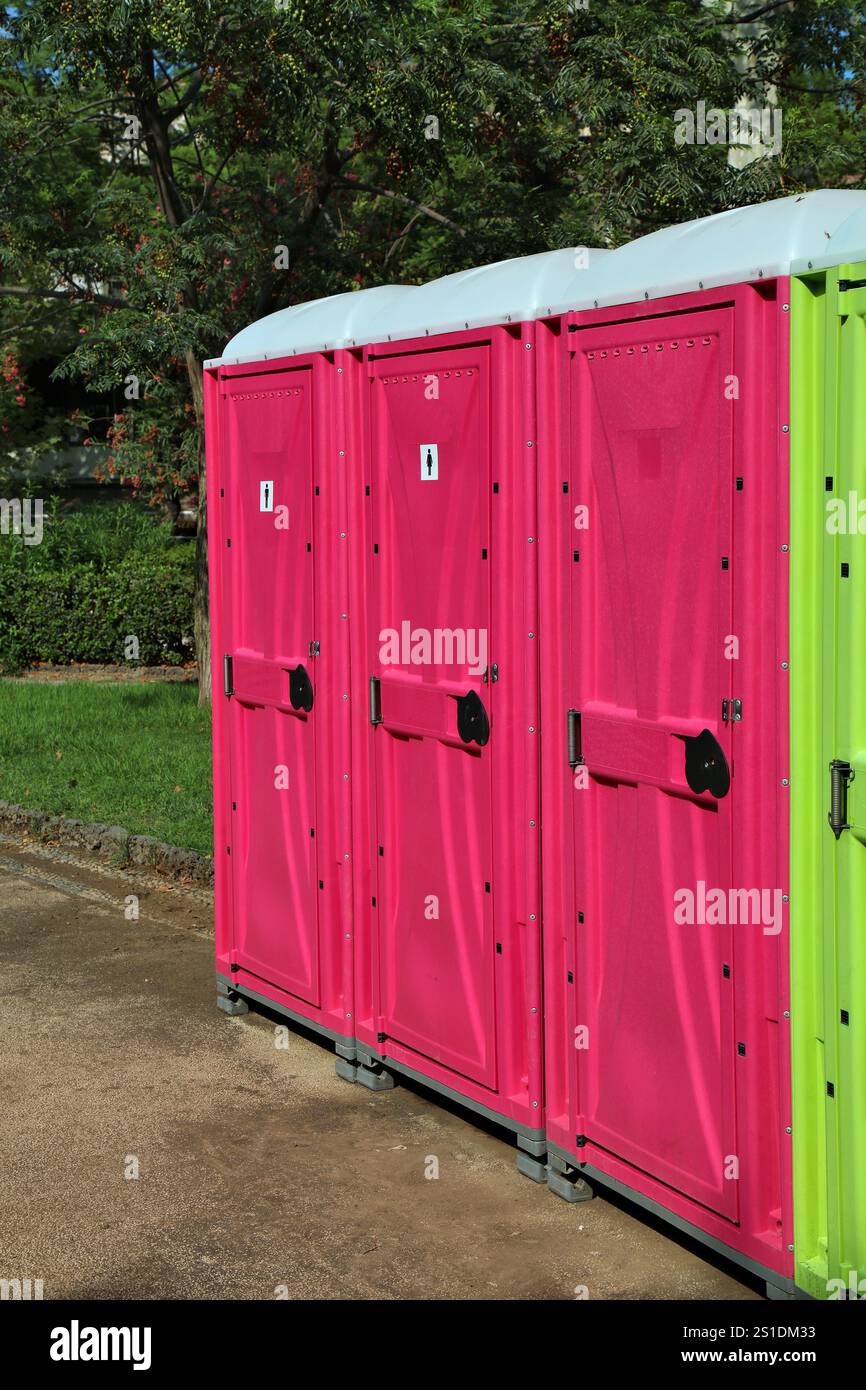Portable public WC in Catania, Italy. Rented plastic portable restrooms for an event in public park. Stock Photo