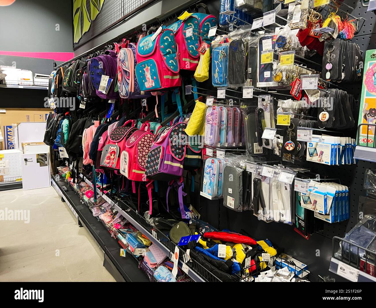 Kyiv, Ukraine - January 03, 2025: Various colorful backpacks and school accessories are neatly arranged on shelves in a store display, offering a vari Stock Photo
