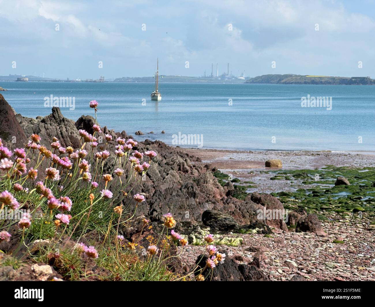 Castle Beach, Near Dale, Pembrokeshire, West Wales with Milford Haven oil refinery in the far distance. - Smartphone Captured Stock Image