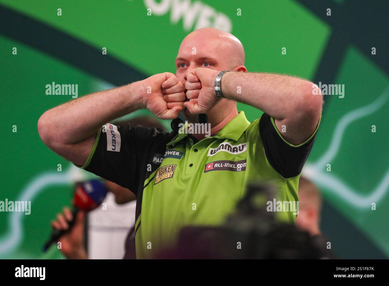 Michael van Gerwen celebrates his win v Chris Dobey and gestures to the