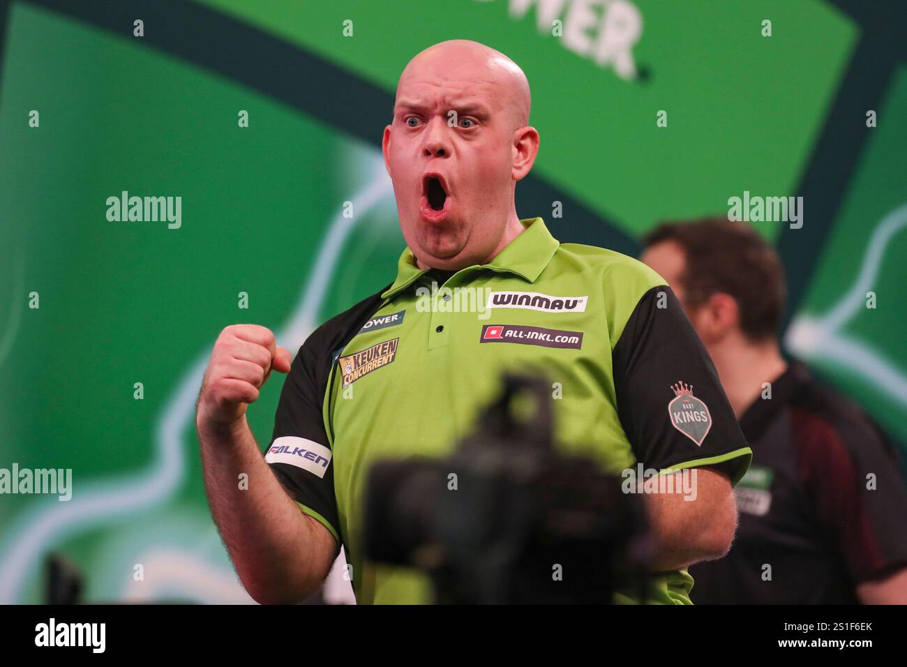 Michael van Gerwen celebrates his win v Chris Dobey and gestures to the