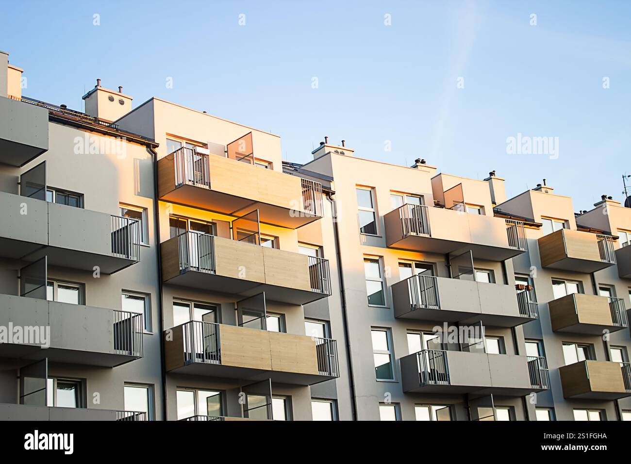 A multi-storey gray building with balconies is built in the city Stock ...