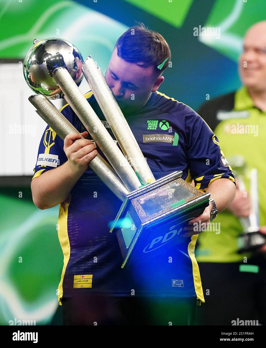 Luke Littler kisses The Sid Waddell Trophy after winning the Paddy