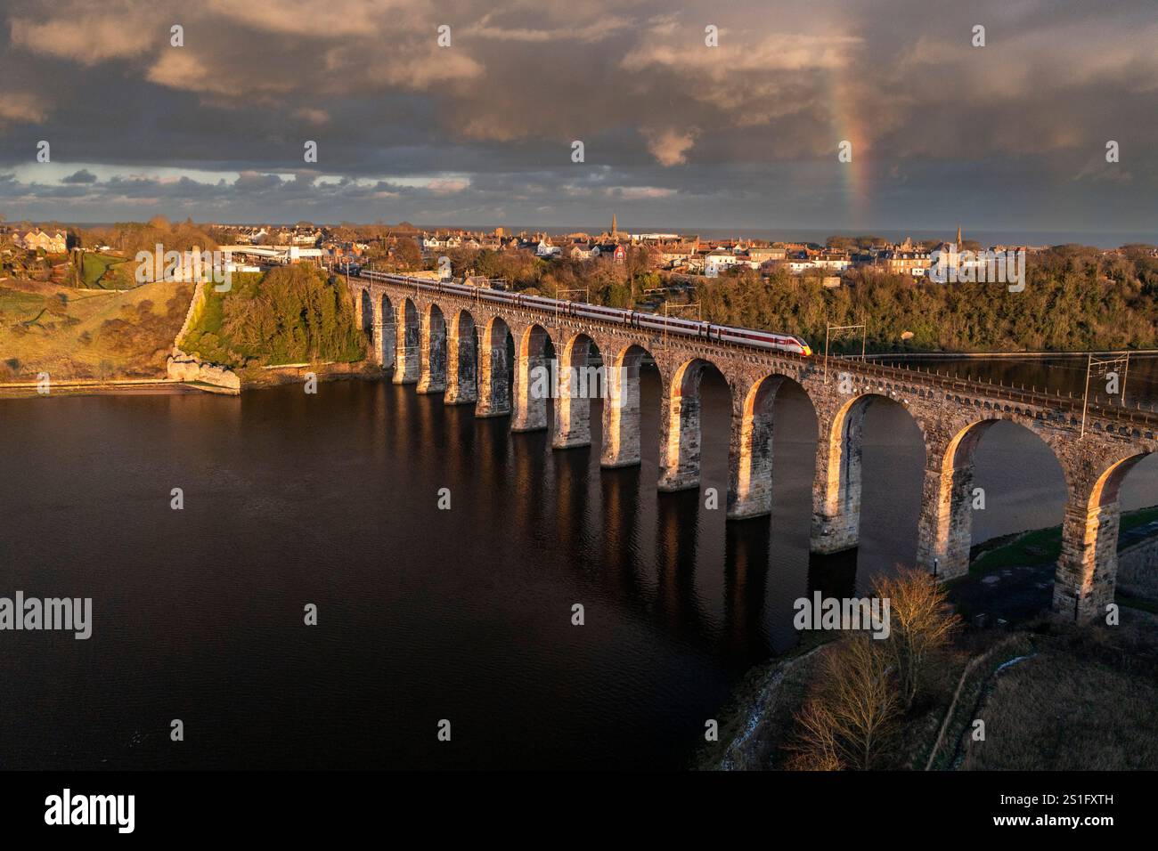 A LNER Azuma train crossing the Royal Border Bridge which carries the main east coast rail link across the River Tweed at Berwick, Northumberland. Stock Photo