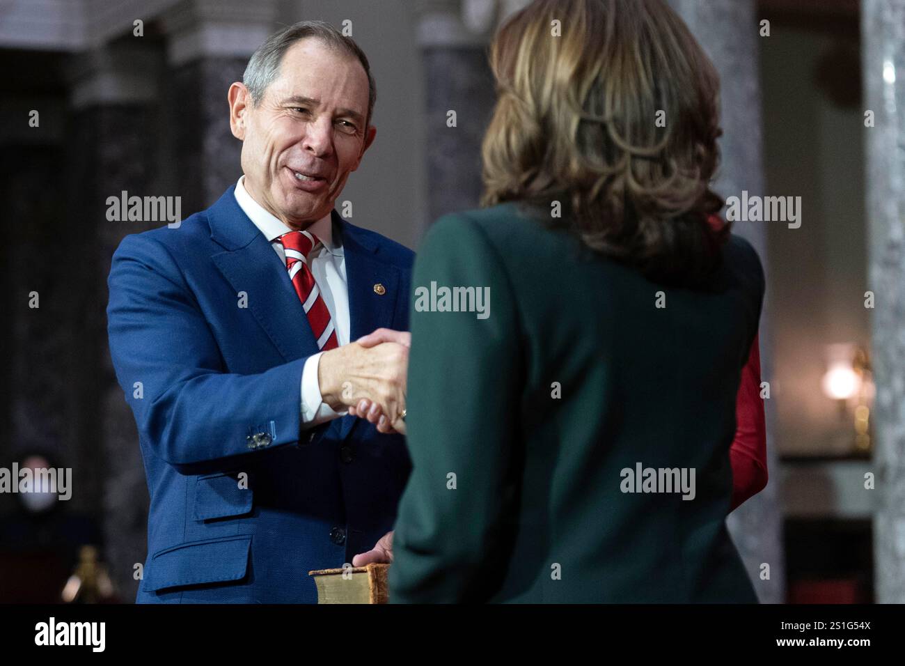 Vice President Kamala Harris, right, shake hands with Sen. John Curtis