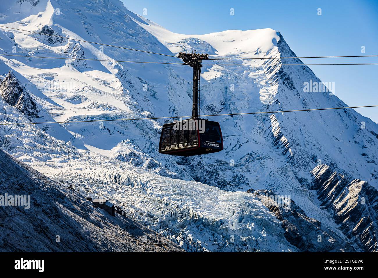 The Aiguille du Midi cable car suspended in front of the Mont Blanc ...