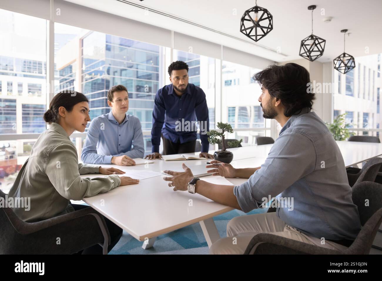 Diverse team of young managers working on startup together Stock Photo