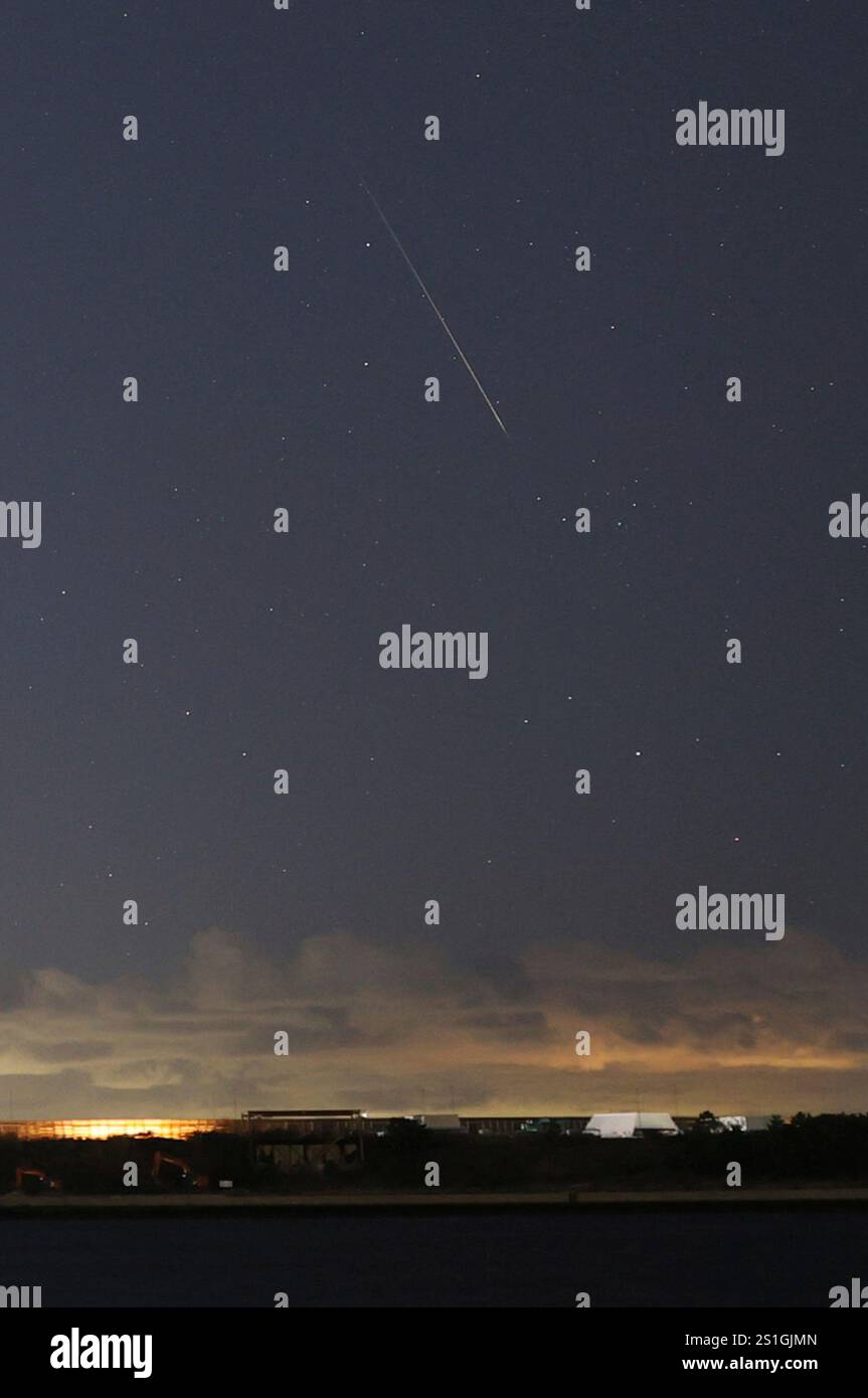 A shooting star shines above Yumeshima, a venue of Osaka, Kansai, Japan