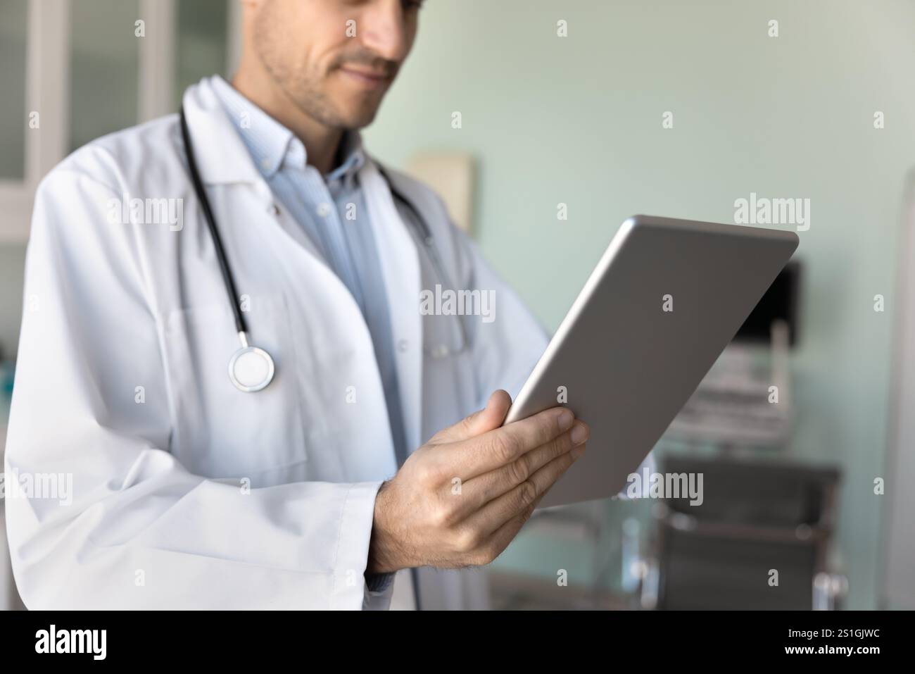 Male physician doctor in white coat using modern technology Stock Photo