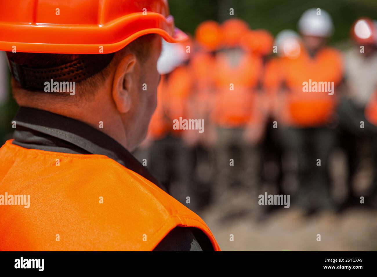 Working together. Worker group wearing vest, safety. Builder man. Helmet builder, hardhat for work. Professional team and portrait of an engineer Stock Photo