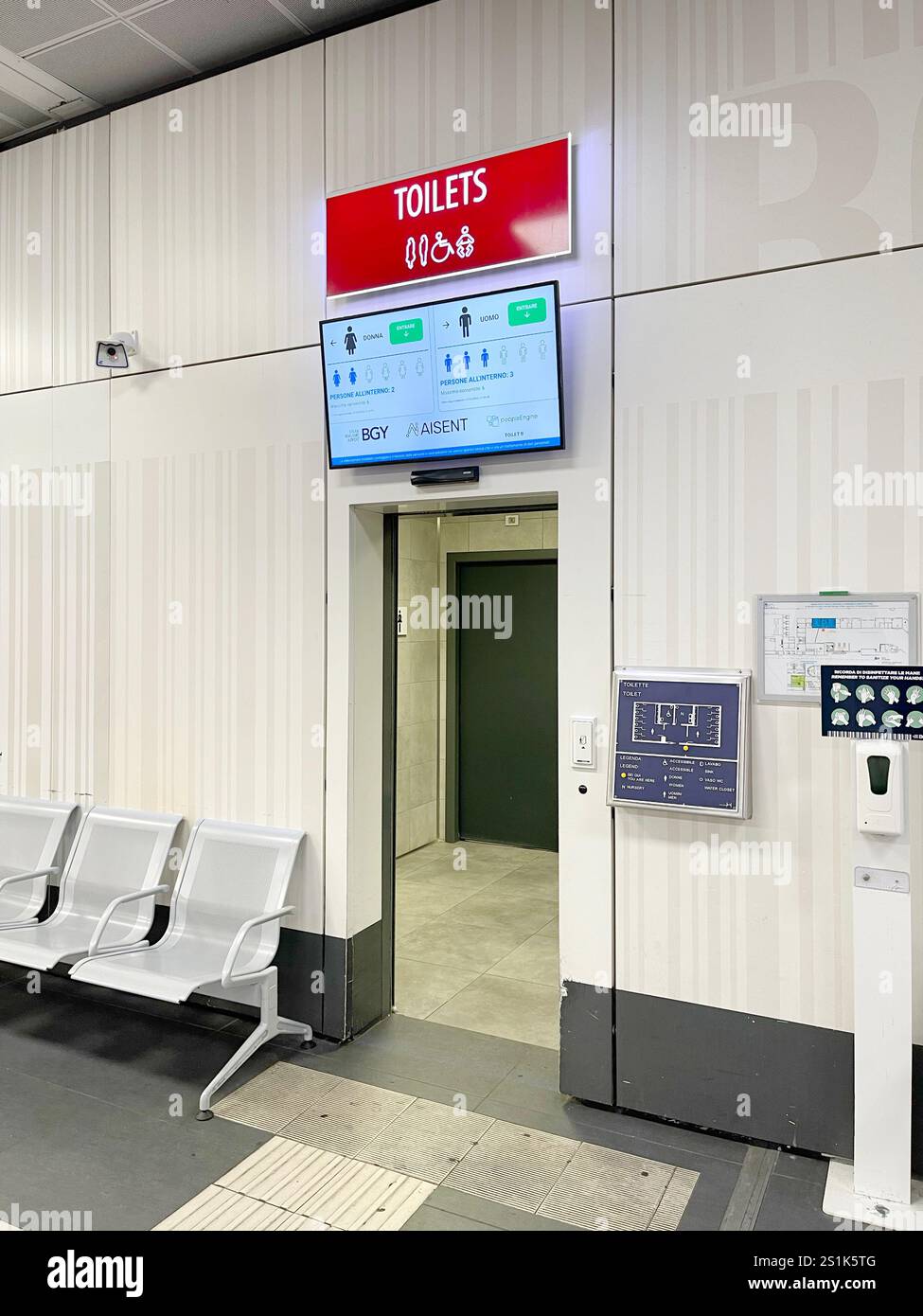Scoreboard in front of entrance to the toilet at airport. Technology and public spaces in city. Information about availability of free seats. Stock Photo