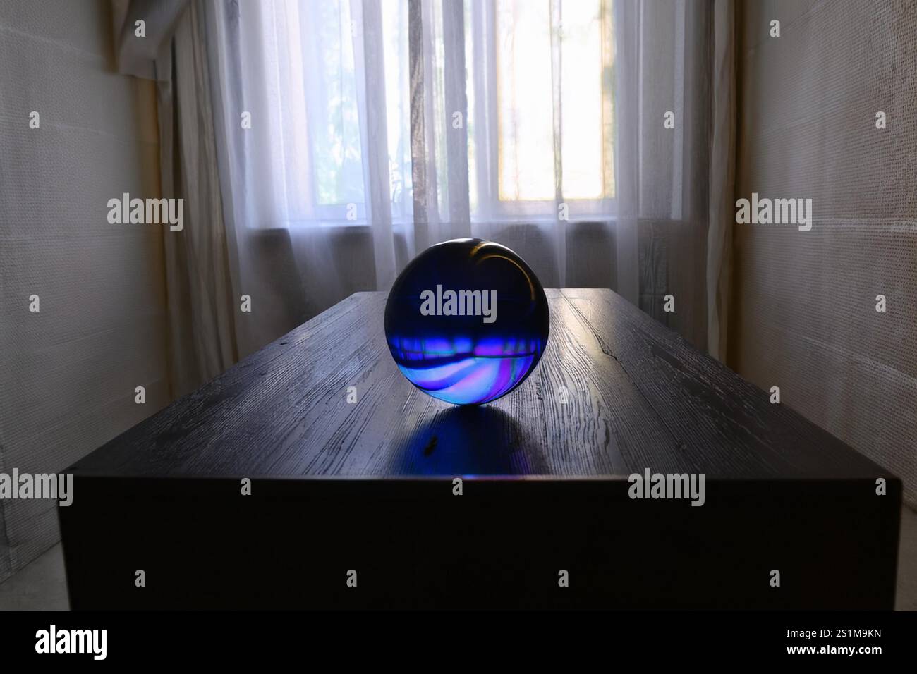 ORB: A mysterious highly intelligent lifeform exist within a spherical ball in a residential home with the ability to sense its occupants emotions. Stock Photo