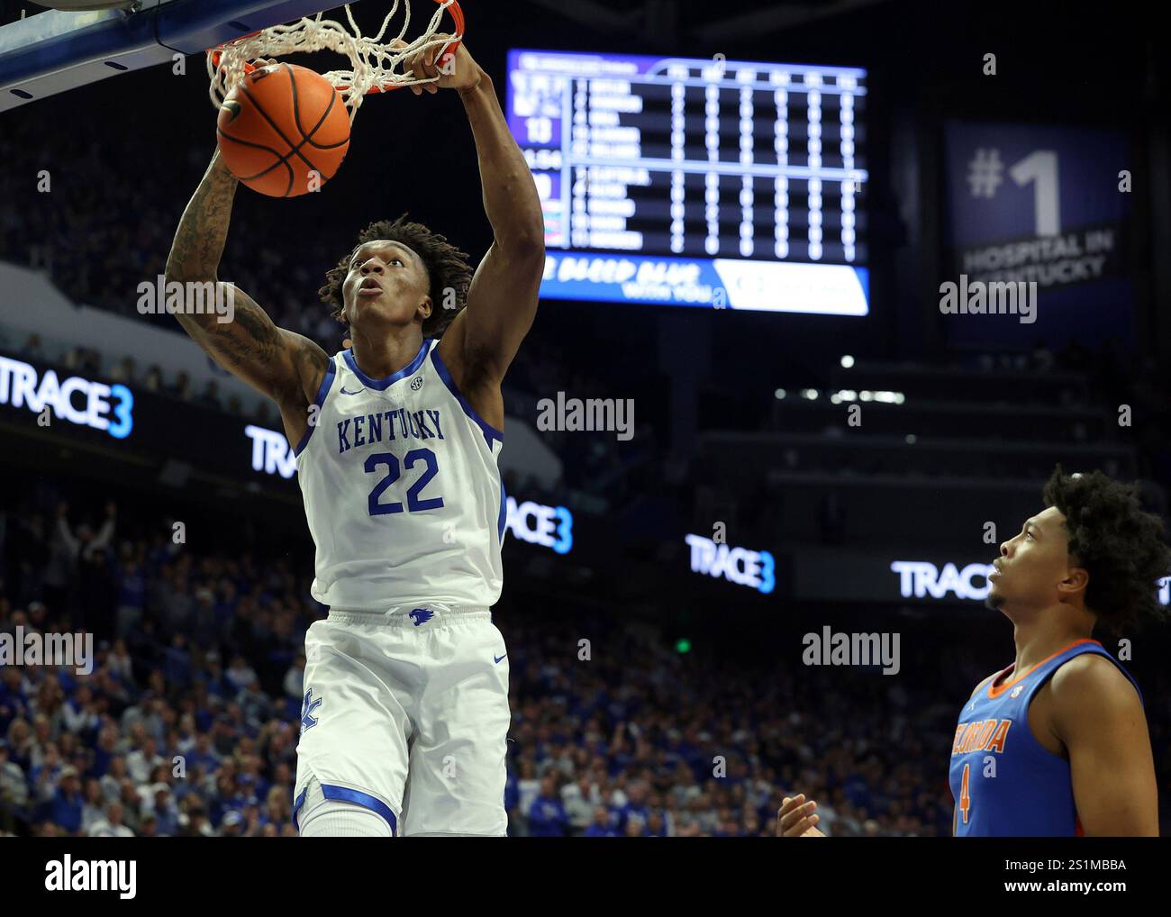 Kentucky's Amari Williams (22) dunks while Florida's Sam Alexis (4
