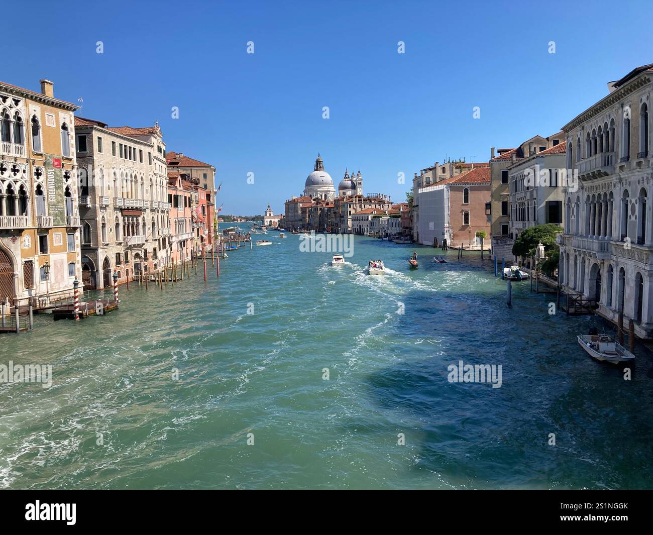 The Grand Canal, Venice, with motor boats, and palaces, under a blue sky - Smartphone Captured Stock Image
