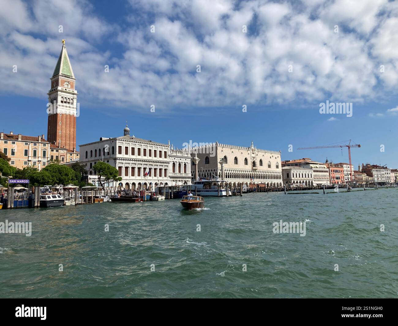 The lagoon near the Grand Canal, Venice, with motor boats, and palaces, under a blue sky - Smartphone Captured Stock Image