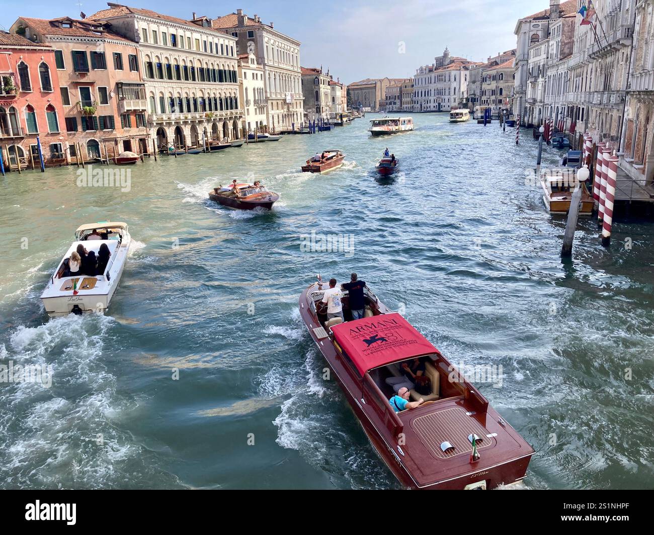 The Grand Canal, Venice, with motor boats, lined by palaces, under a blue sky - Smartphone Captured Stock Image